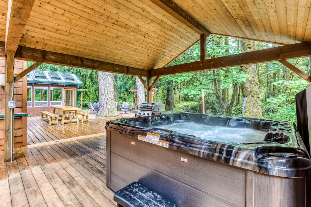 Dog-friendly creekside home with entertainment barn, private hot tub & firepit