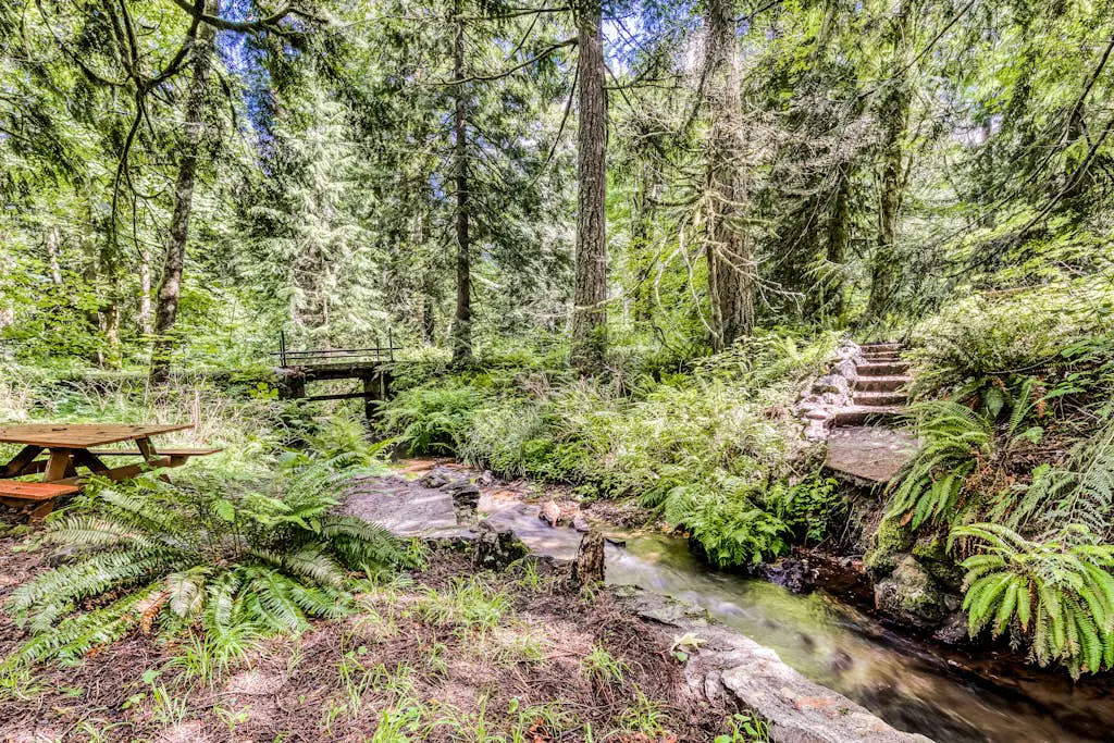 Dog-friendly creekside home with entertainment barn, private hot tub & firepit