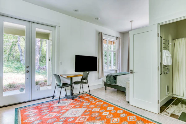 Dog-friendly studio with river view, patio, grill, & shared W/D