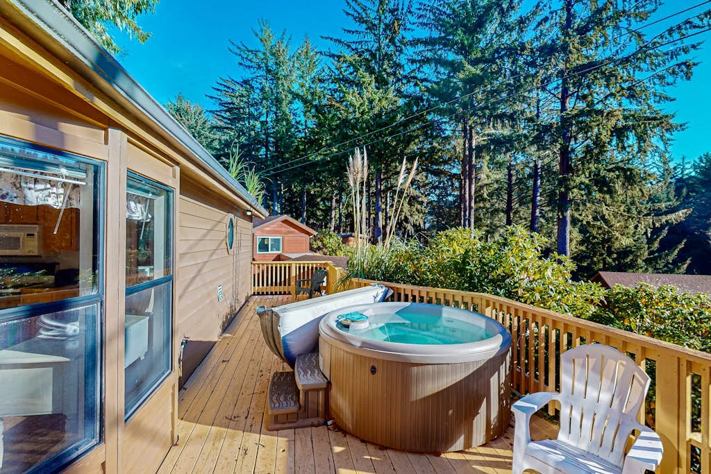 Cozy abode steps from the beach with a private hot tub and nautical theme