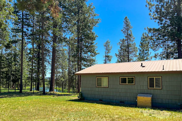 Quaint, riverfront home with woodstove, patio, deck, board games & washer/dryer
