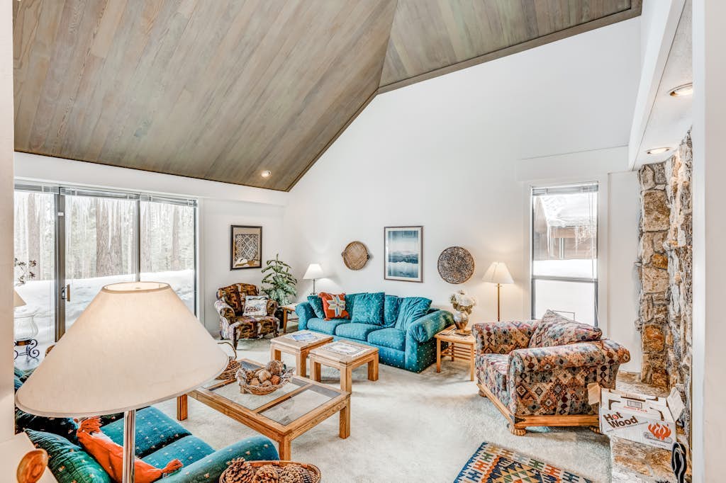Golf-course-front home with great deck, game room, fireplace & forest views