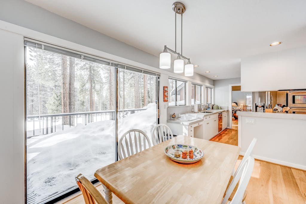 Golf-course-front home with great deck, game room, fireplace & forest views