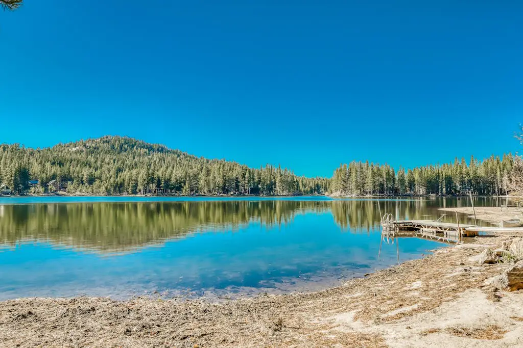 Family-friendly, lakefront getaway with a gas fireplace, furnished deck, & views
