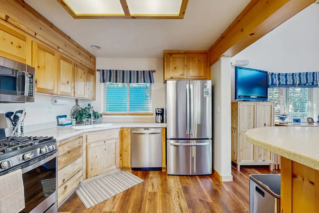Family-friendly, lakefront getaway with a gas fireplace, furnished deck, & views