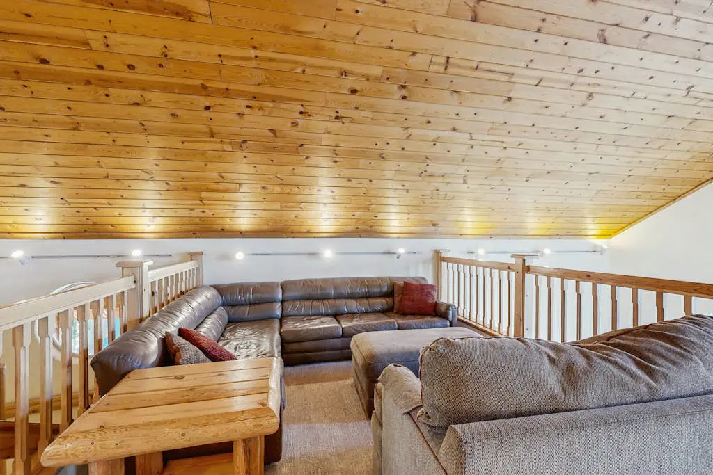 Family-friendly, lakefront getaway with a gas fireplace, furnished deck, & views
