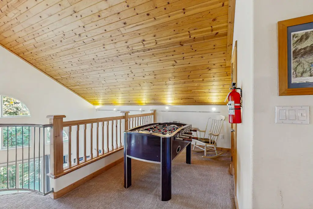 Family-friendly, lakefront getaway with a gas fireplace, furnished deck, & views