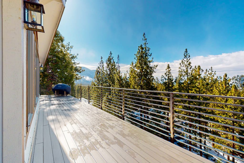 Luxury lake-view home with spacious deck, sauna, golf room, & wet bar