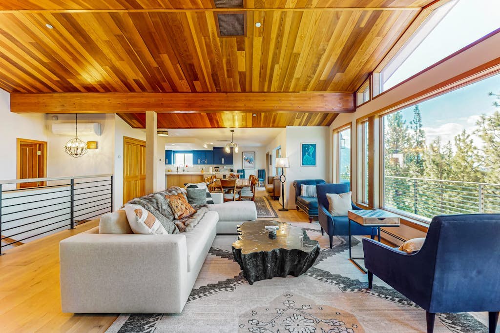 Luxury lake-view home with spacious deck, sauna, golf room, & wet bar