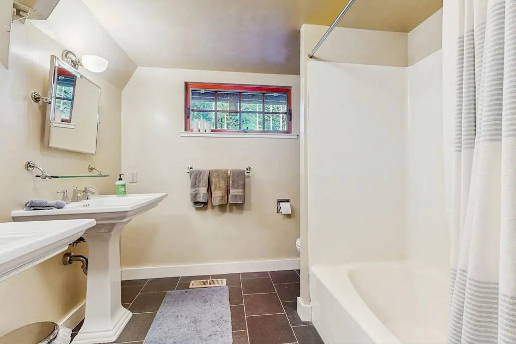 Luxury lakefront home with private hot tub, on-site dock, fireplace & HOA beach