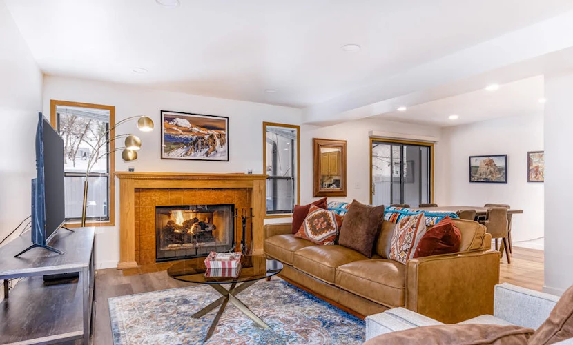 Central townhouse with private hot tub, wood fireplace, & ski shuttle access