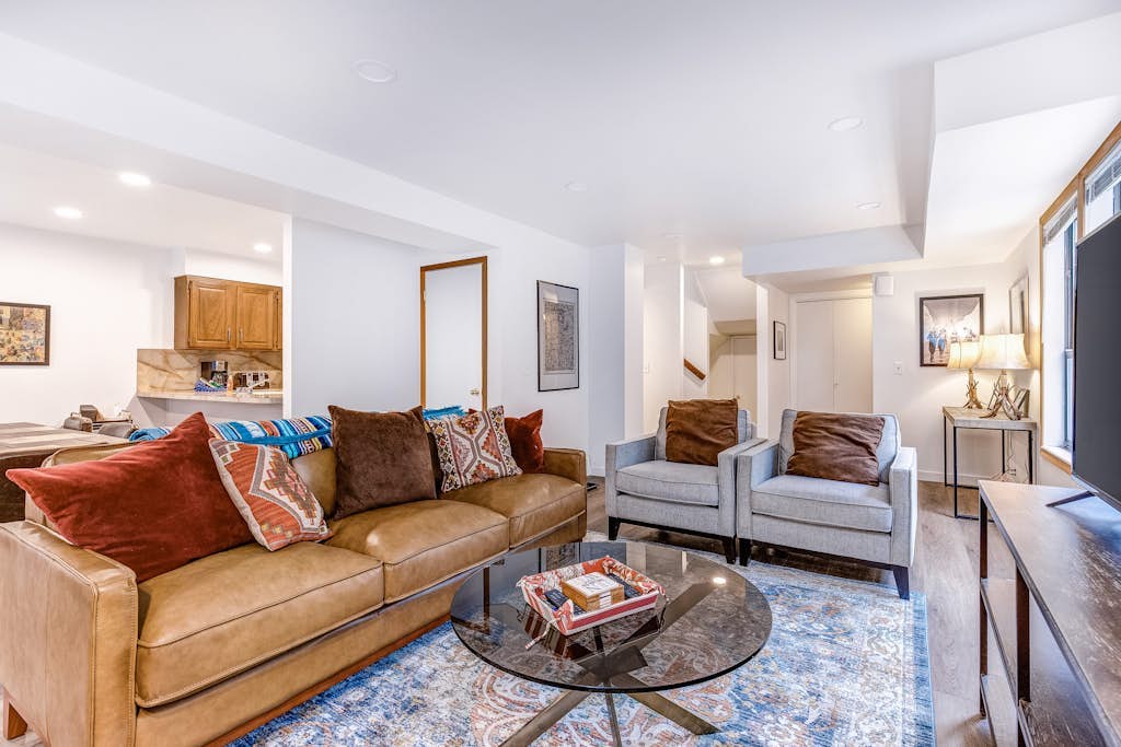 Central townhouse with private hot tub, wood fireplace, & ski shuttle access