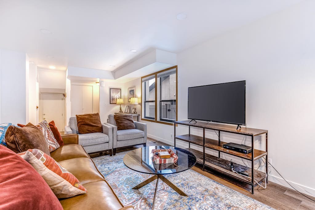 Central townhouse with private hot tub, wood fireplace, & ski shuttle access