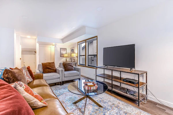 Central townhouse with private hot tub, wood fireplace, & ski shuttle access