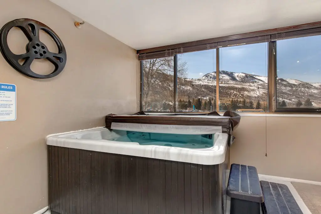 Ski-in/out condo with WiFi, private hot tub, fireplace, shared pool, & gym