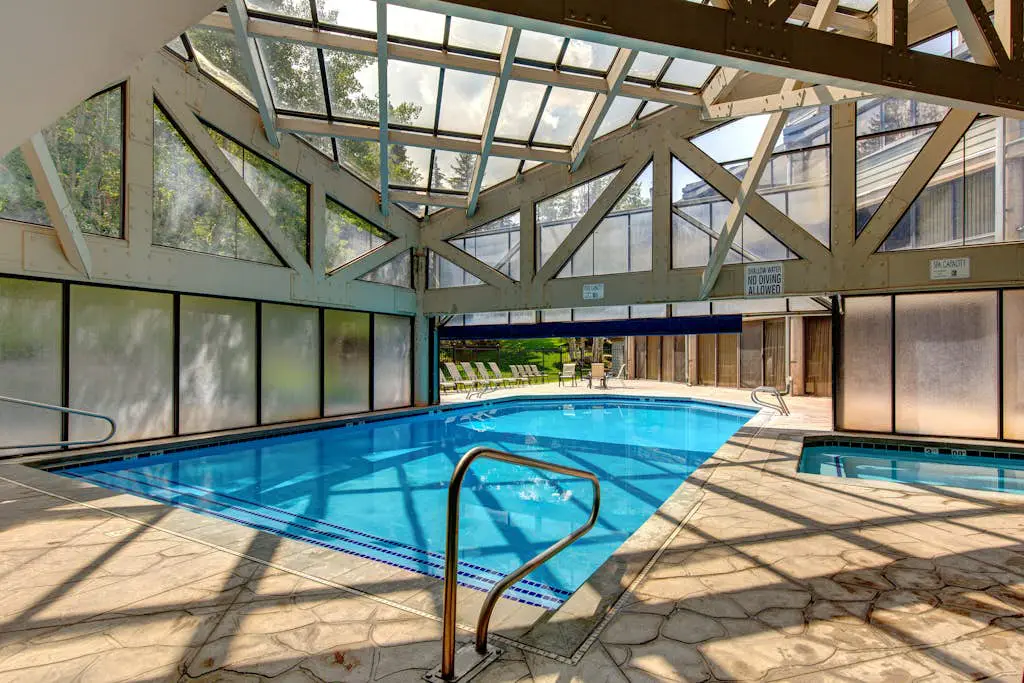 Ski-in/out condo with WiFi, private hot tub, fireplace, shared pool, & gym
