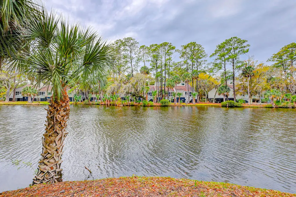 Coastal townhome with riverfront views, deck, & W/D - pool and athletic courts