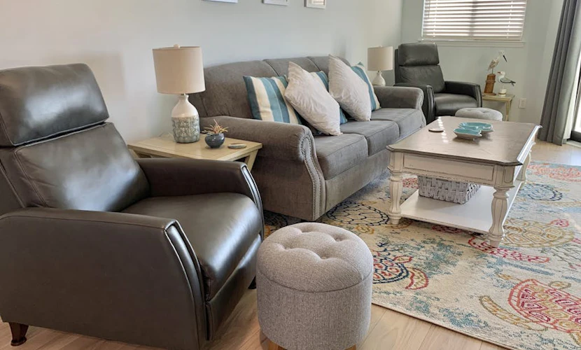 Inviting waterfront condo with marsh view, shared pool, balcony & central AC