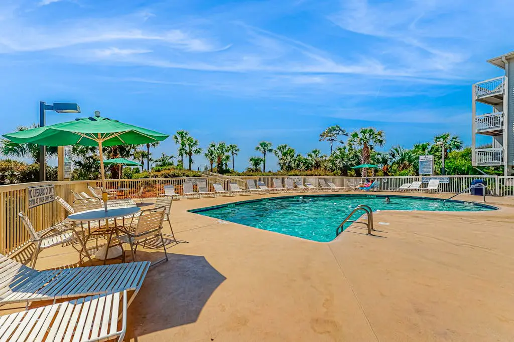 Condo with Coligny Beach views, outdoor pool, beach access, balcony, W/D, & AC