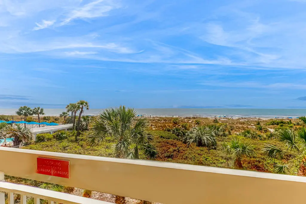 Condo with Coligny Beach views, outdoor pool, beach access, balcony, W/D, & AC