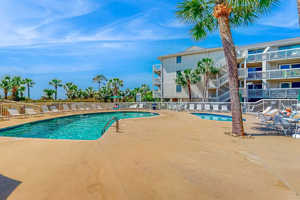Condo with Coligny Beach views, outdoor pool, beach access, balcony, W/D, & AC