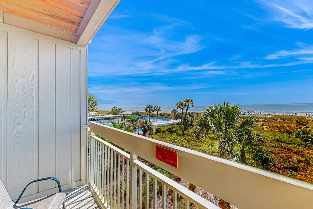 Condo with Coligny Beach views, outdoor pool, beach access, balcony, W/D, & AC