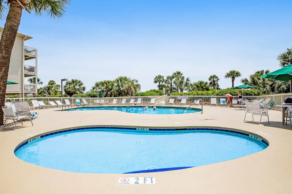 Condo with Coligny Beach views, outdoor pool, beach access, balcony, W/D, & AC