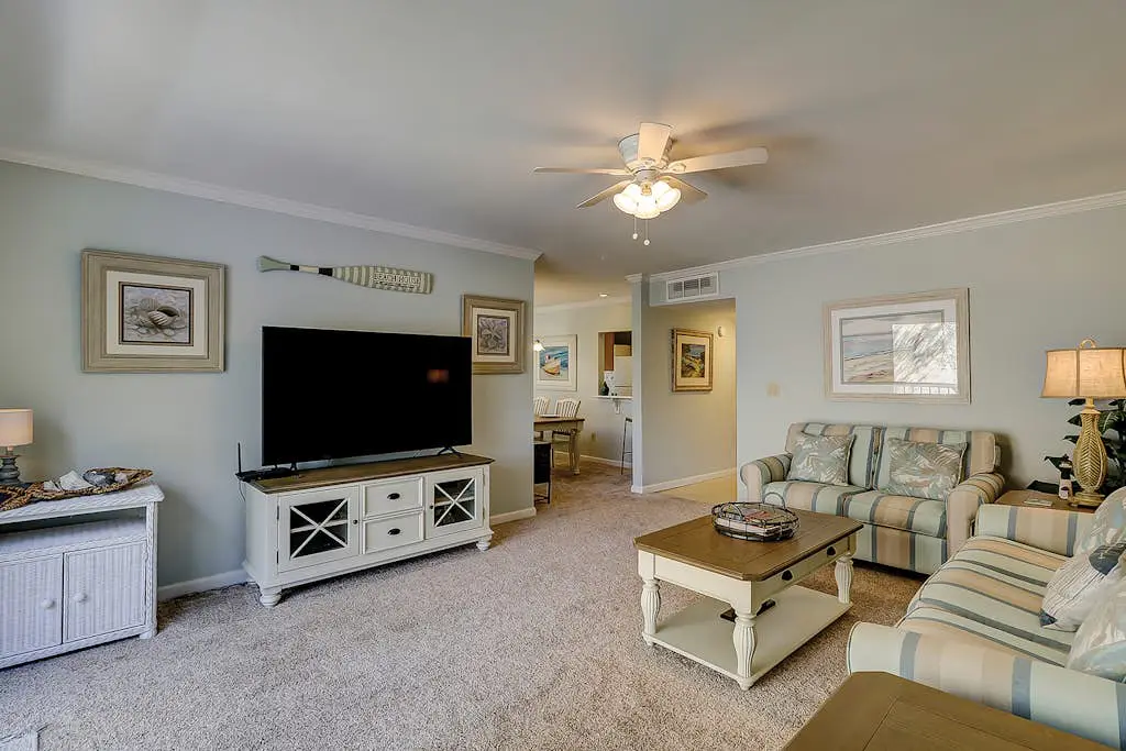 Waterfront condo with seasonal pools, hot tub, balcony, AC, & WD