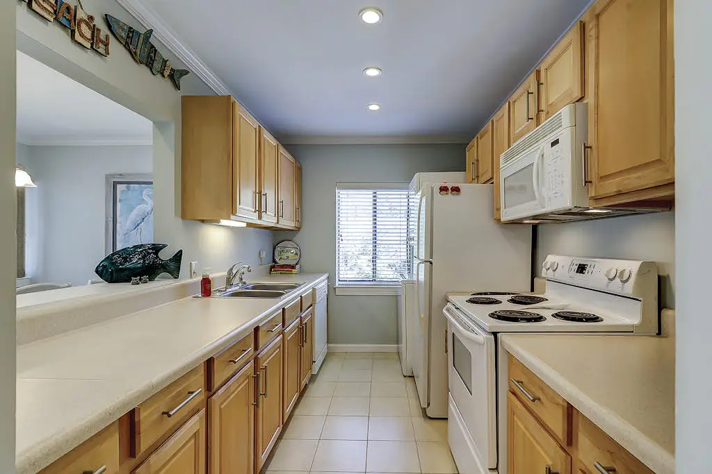 Waterfront condo with seasonal pools, hot tub, balcony, AC, & WD