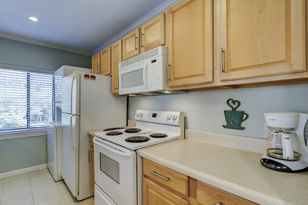 Waterfront condo with seasonal pools, hot tub, balcony, AC, & WD