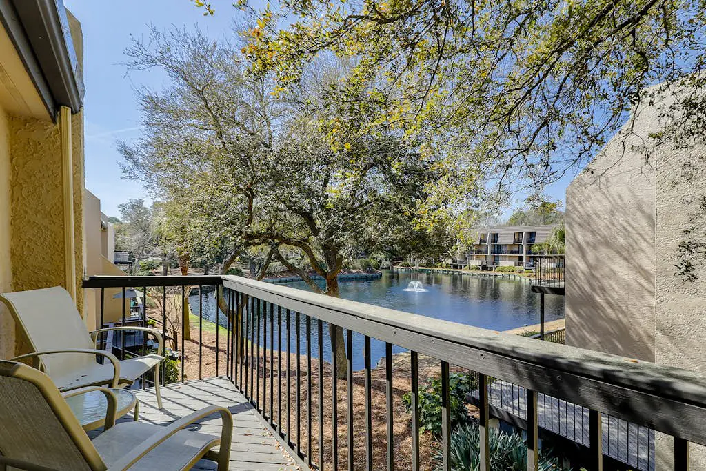 Waterfront condo with seasonal pools, hot tub, balcony, AC, & WD