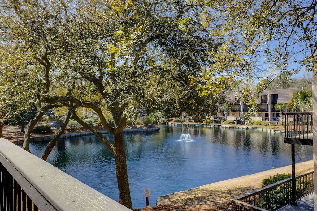 Waterfront condo with seasonal pools, hot tub, balcony, AC, & WD