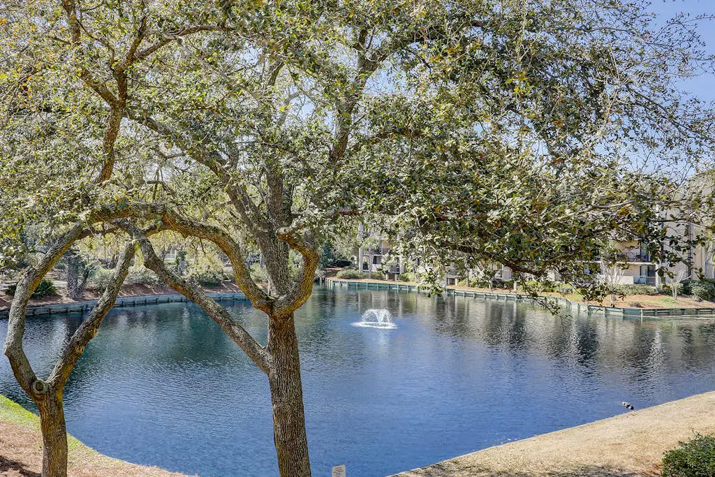 Waterfront condo with seasonal pools, hot tub, balcony, AC, & WD