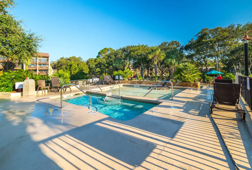 Waterfront condo with seasonal pools, hot tub, balcony, AC, & WD