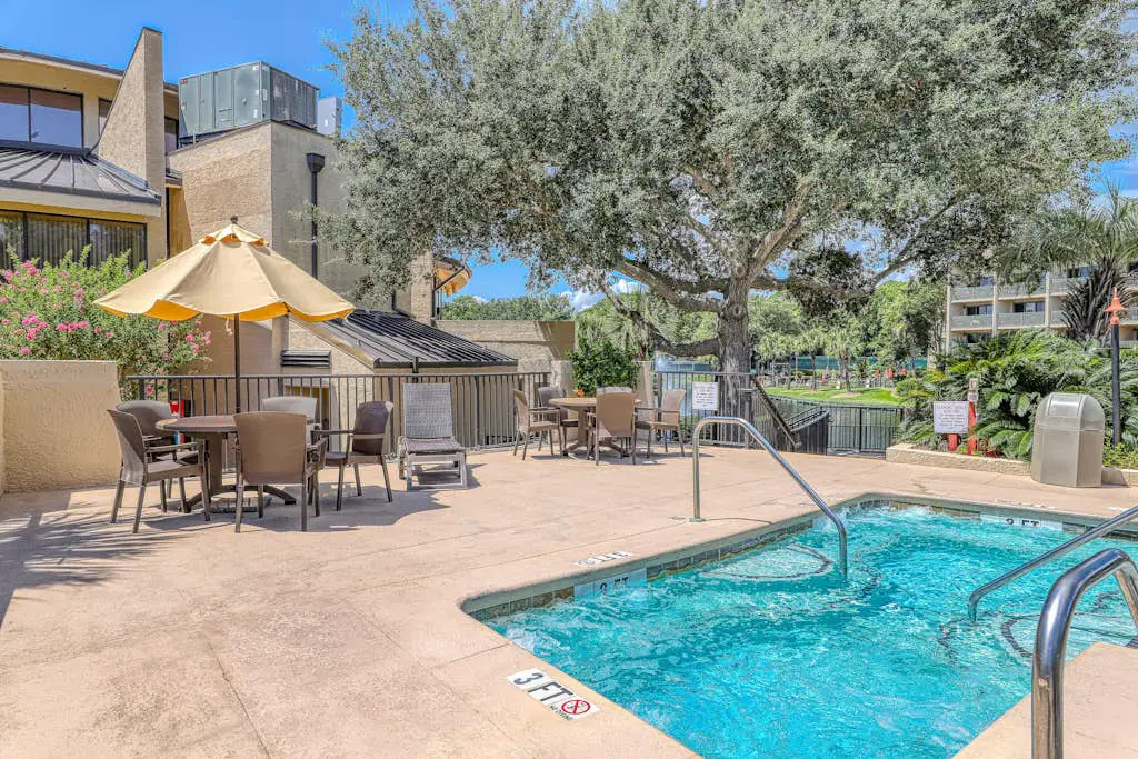 Waterfront condo with seasonal pools, hot tub, balcony, AC, & WD