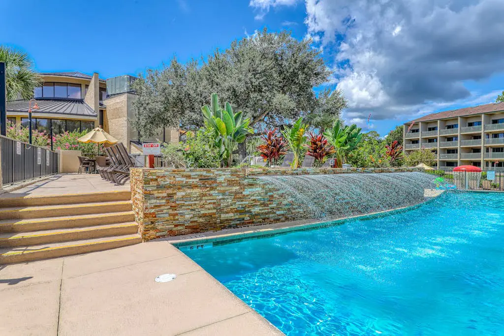 Waterfront condo with seasonal pools, hot tub, balcony, AC, & WD