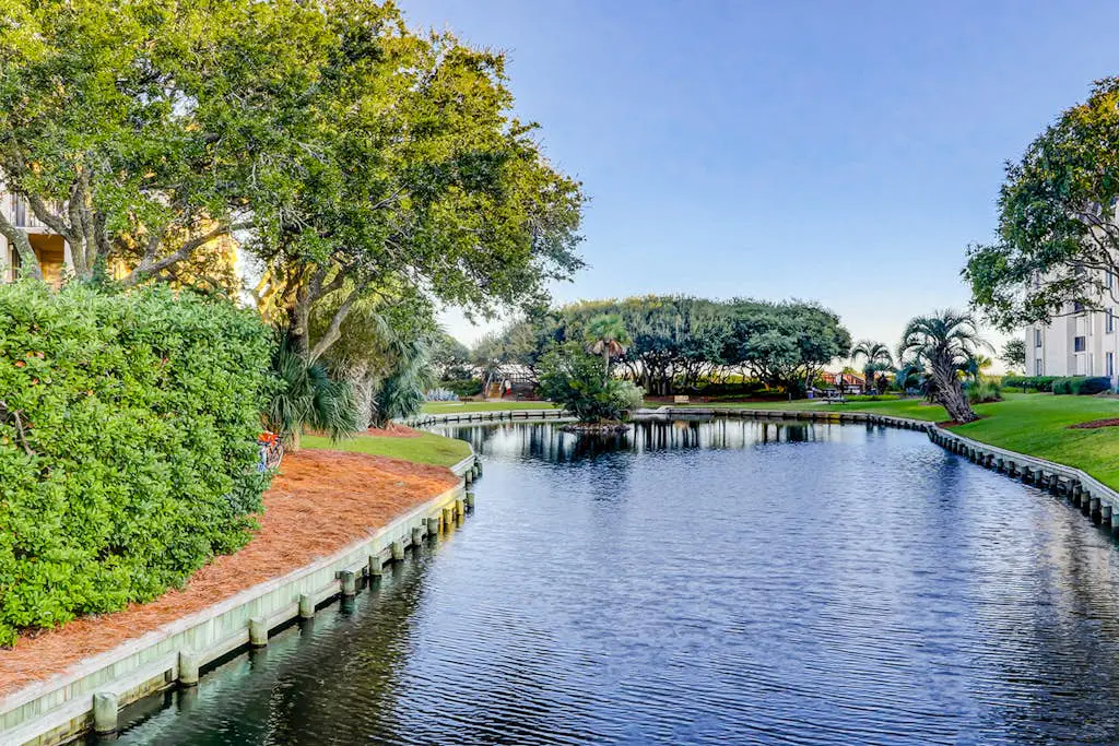 Waterfront condo with seasonal pools, hot tub, balcony, AC, & WD