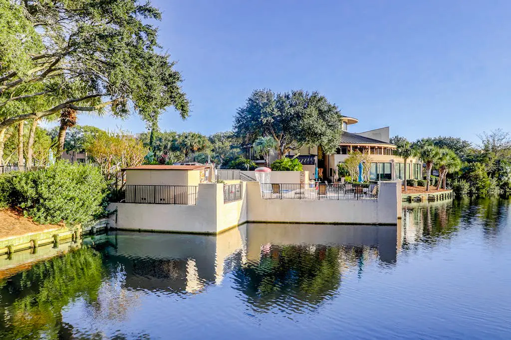 Waterfront condo with seasonal pools, hot tub, balcony, AC, & WD