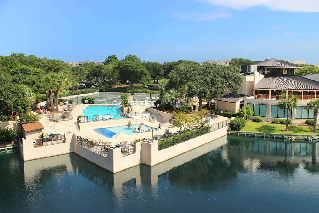 Waterfront condo with seasonal pools, hot tub, balcony, AC, & WD