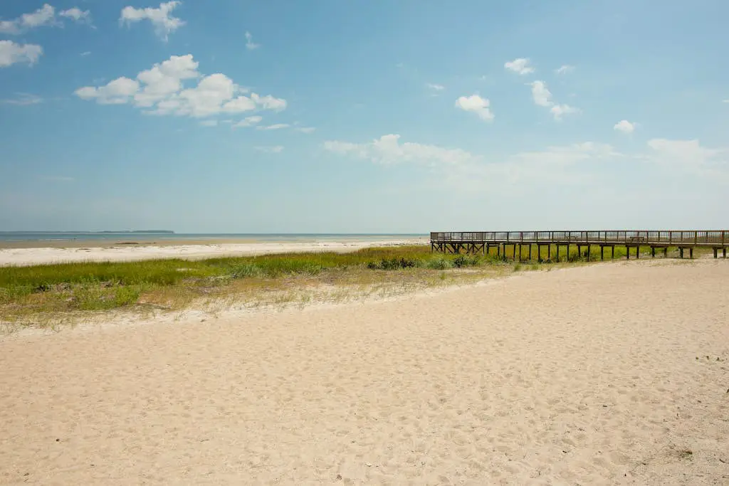 3rd-floor condo with water views, balcony, pools, gym, & beach access