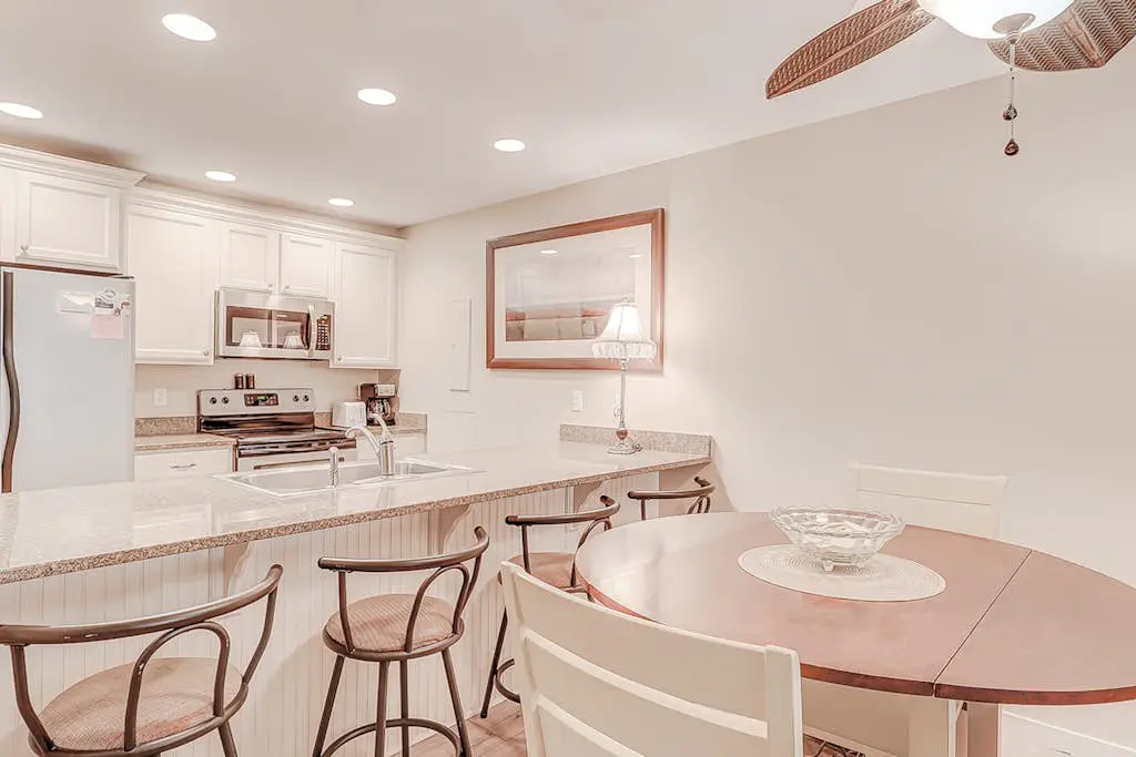 Dog-friendly condo with pool, central AC, & washer/dryer - quick walk to beach