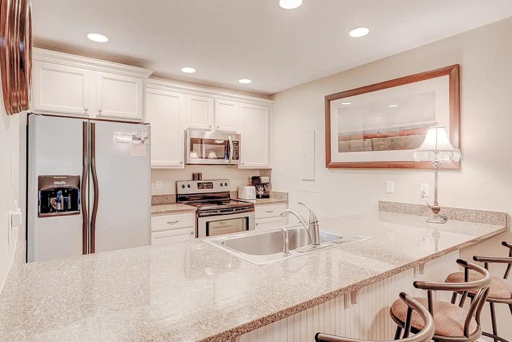 Dog-friendly condo with pool, central AC, & washer/dryer - quick walk to beach