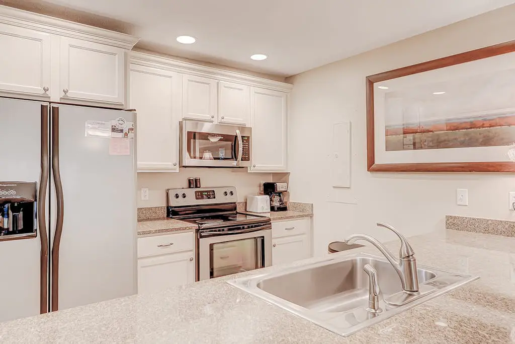 Dog-friendly condo with pool, central AC, & washer/dryer - quick walk to beach