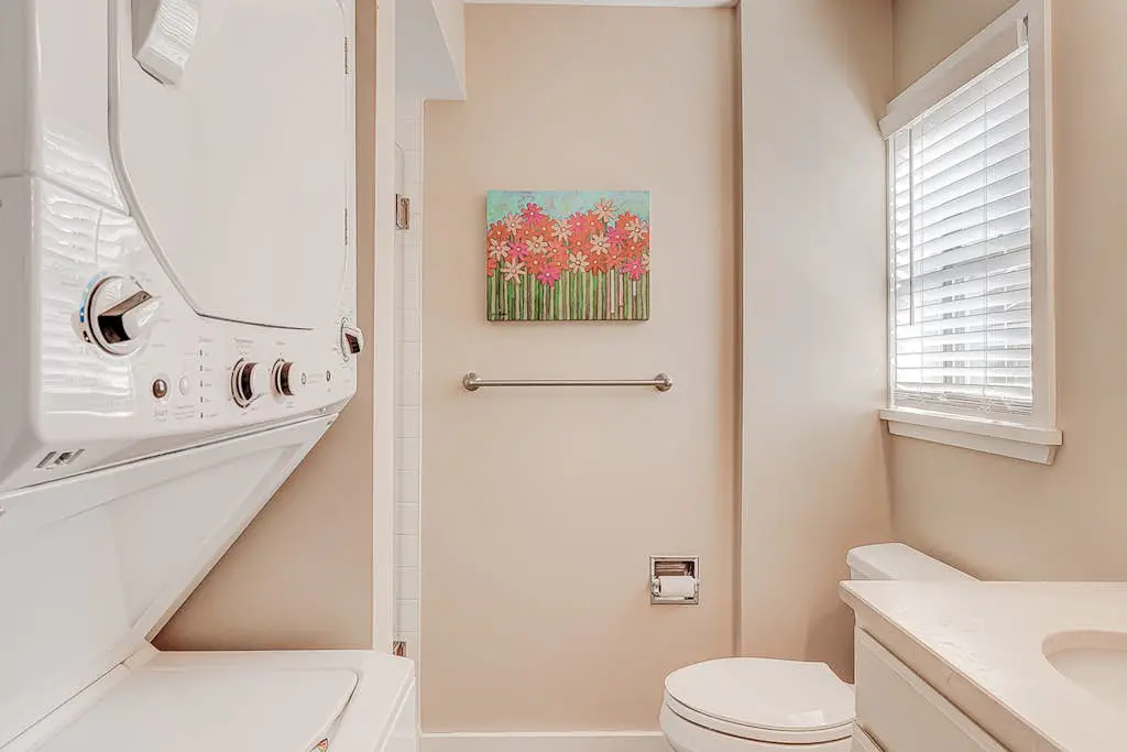 Dog-friendly condo with pool, central AC, & washer/dryer - quick walk to beach