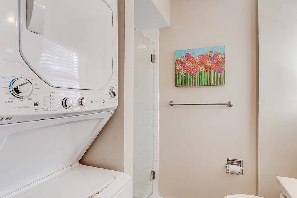 Dog-friendly condo with pool, central AC, & washer/dryer - quick walk to beach
