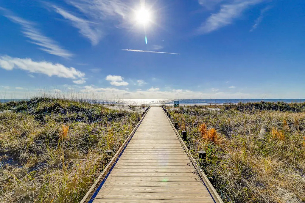 Beach access condo with deck, pool, washer/dryer, and AC - snowbird-friendly