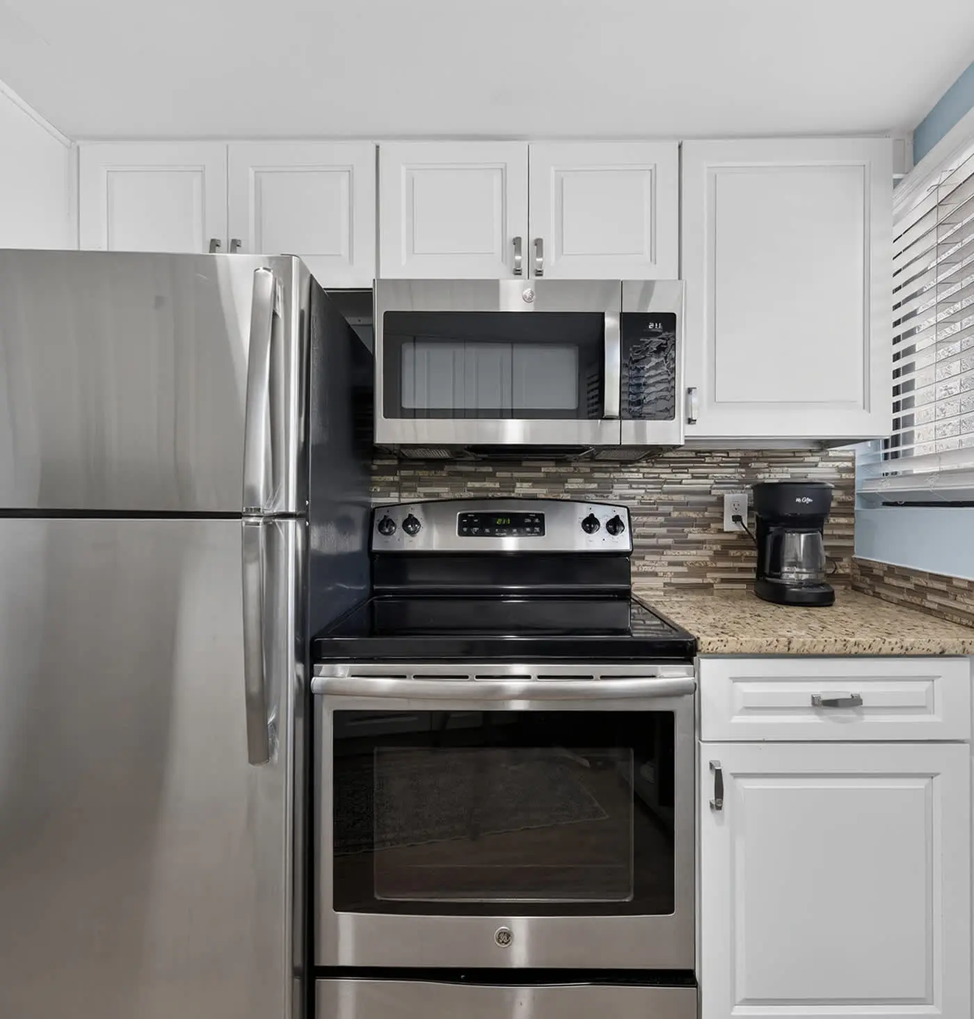 Beach access condo with deck, pool, washer dryer, and AC - snowbird-friendly