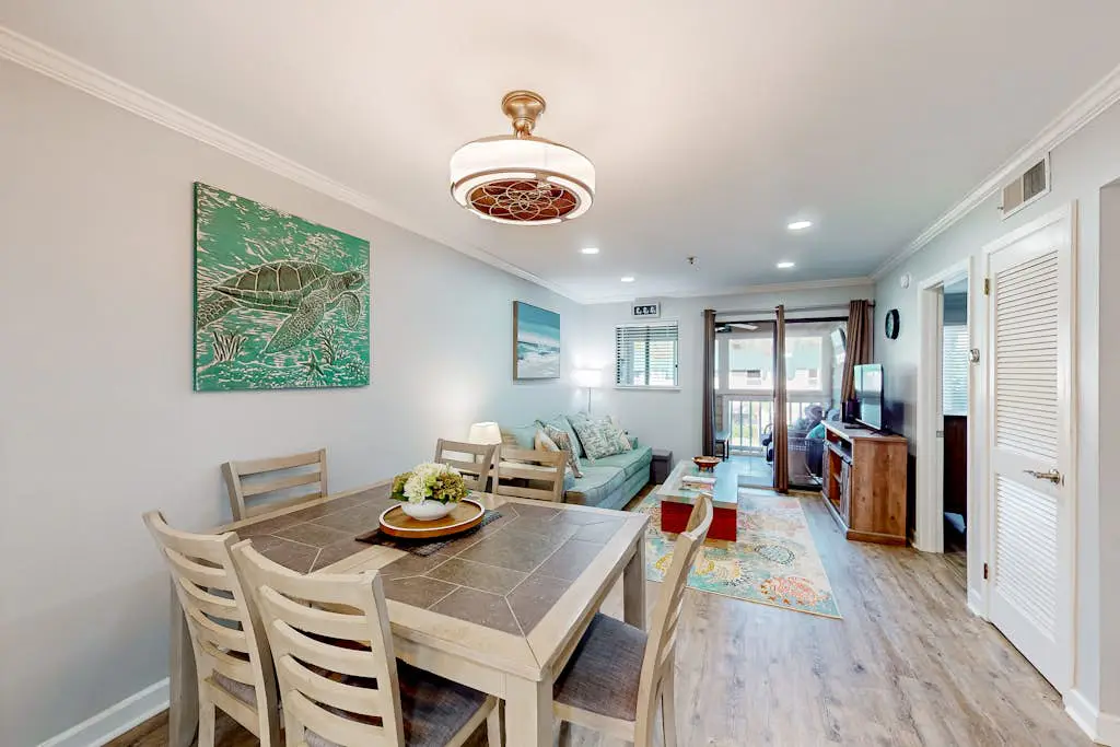 Waterfront villa with resort amenities, beach access, open layout, AC, & W/D