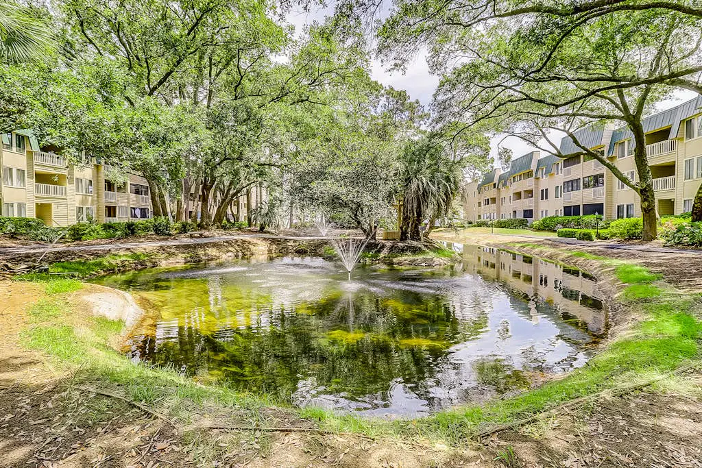 Waterfront villa with resort amenities, beach access, open layout, AC, & W/D