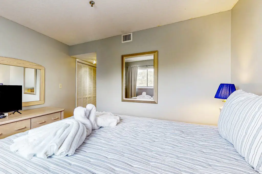 Updated coastal villa with pools, athletic courts, gym, smart TVs, AC, & W/D